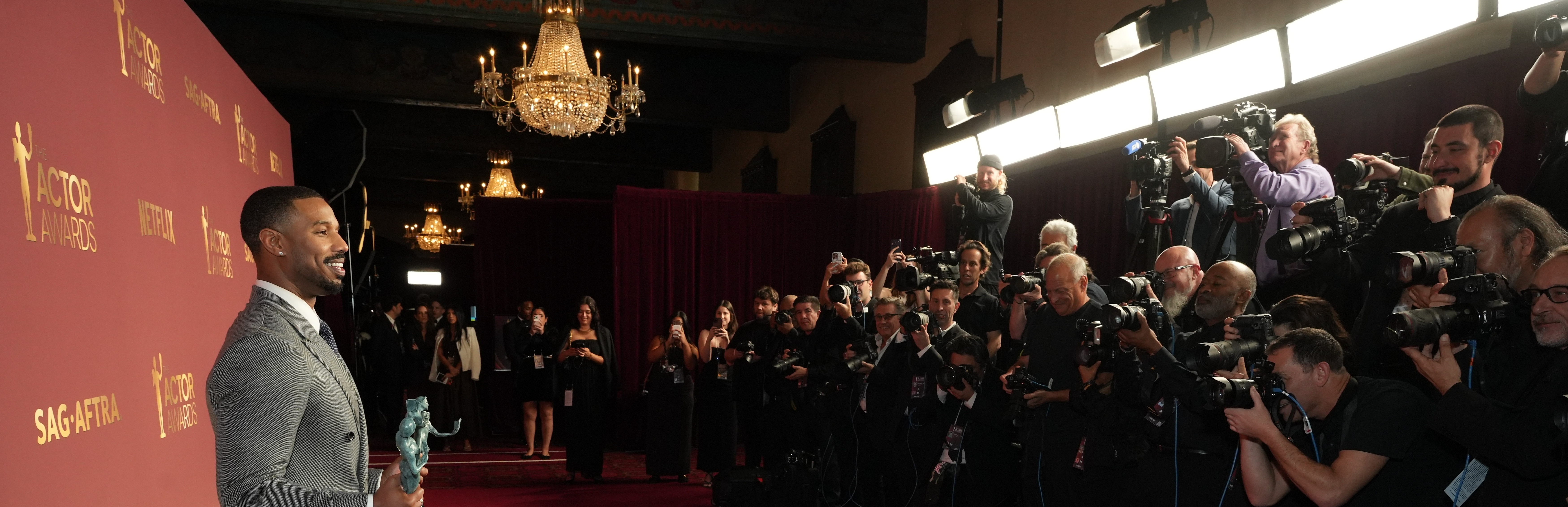 Michael B Jordan facing row of photographers at Actor Awards event